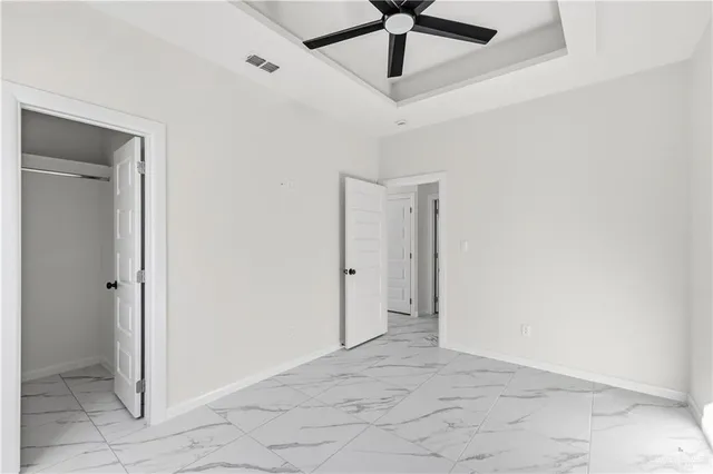a view of a ceiling fan and a window