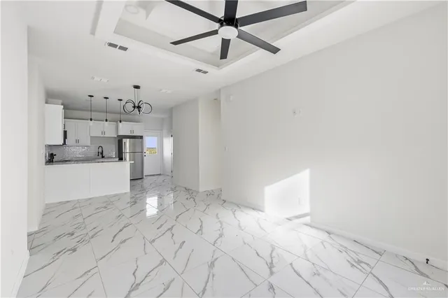 a view of a kitchen with a sink and cabinets