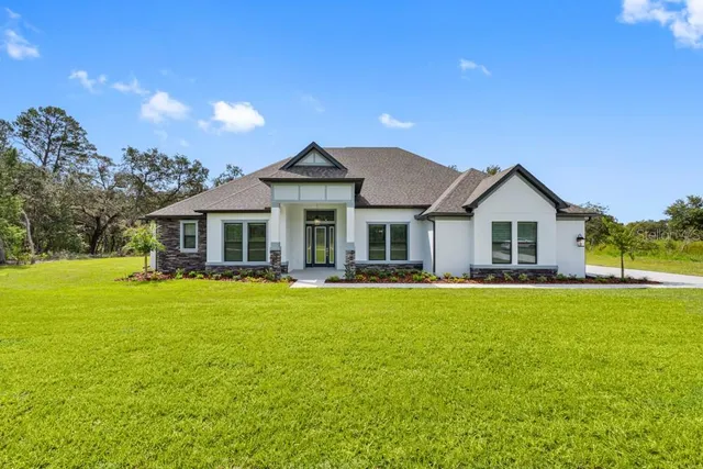 a front view of a house with swimming pool having outdoor seating