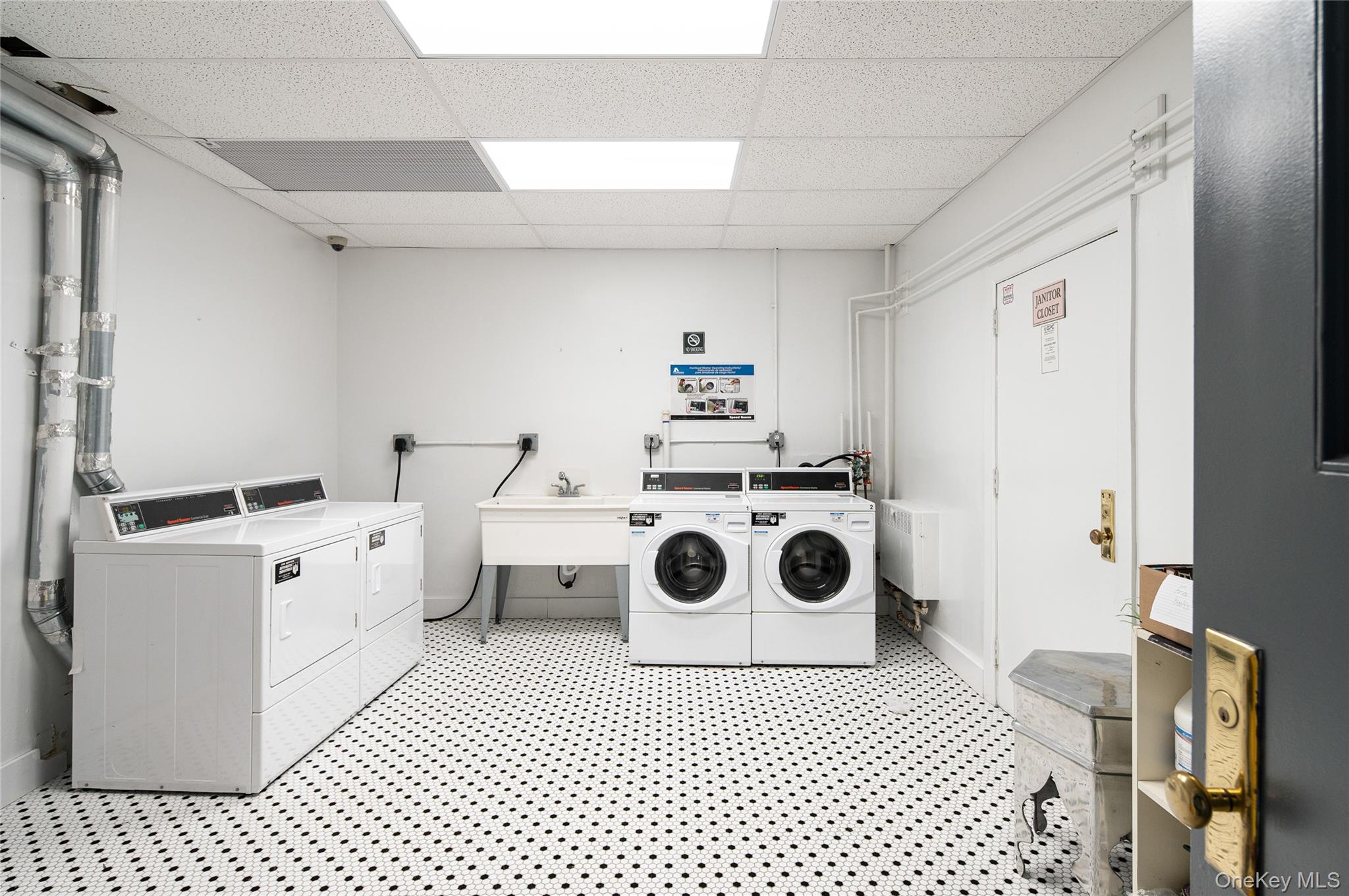 633 Old Post Road, Unit 23 Bedford, NY 10506 - Photo 7 of 10 Shared laundry featuring a drop ceiling and separate washer and dryer