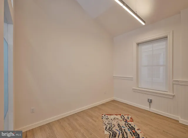 a living room with furniture a window and a glass door shower