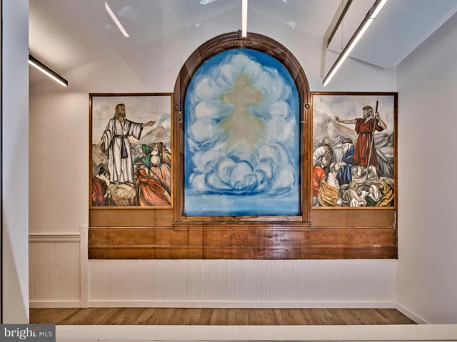 a view of a door with a painting on the wall