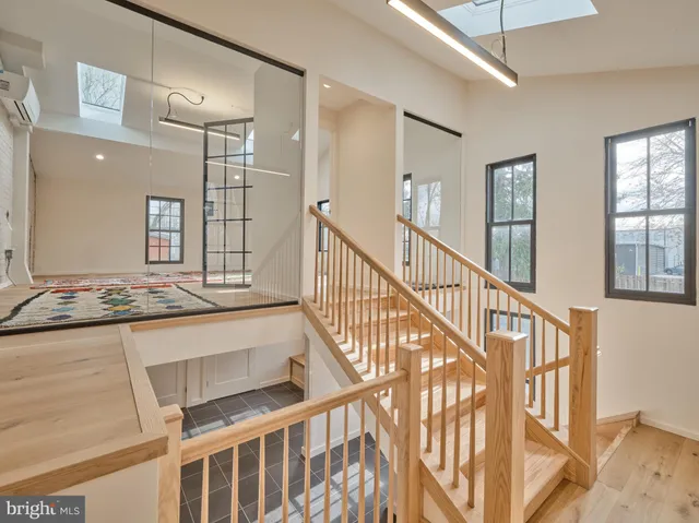 a view of a bedroom with wooden floor