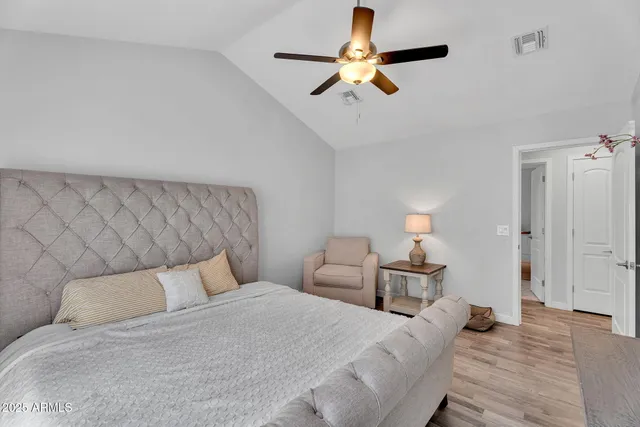 a bedroom with a bed and a lamp