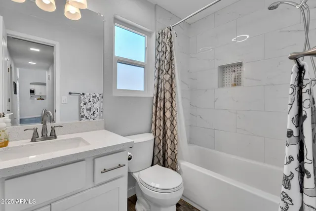 a bathroom with a sink a toilet and a bathtub