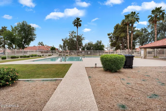 a view of yard with swimming pool and green space