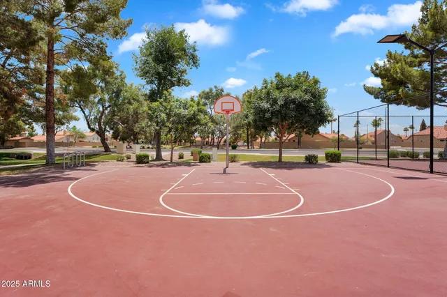 a view of a playground with basketball court