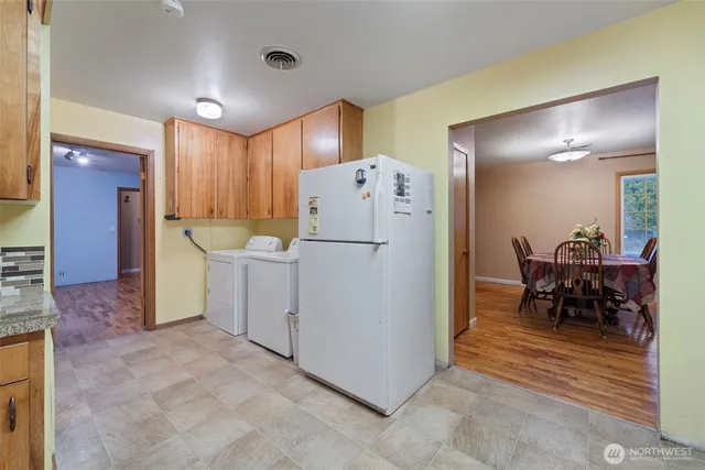 a kitchen with a refrigerator sink and cabinets
