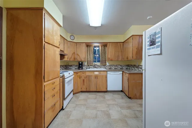 a kitchen with granite countertop cabinets stainless steel appliances and a counter space