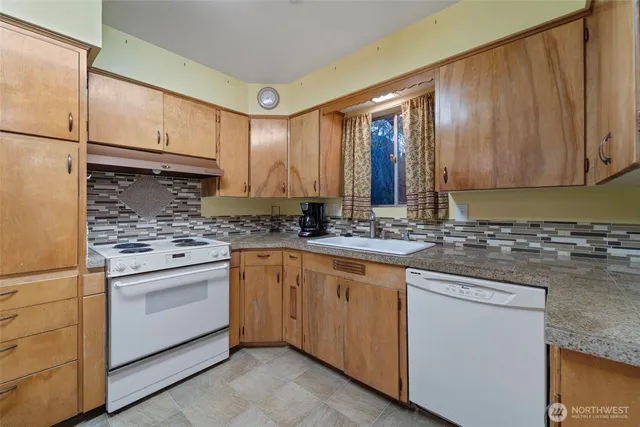 a kitchen with a stove cabinets and refrigerator