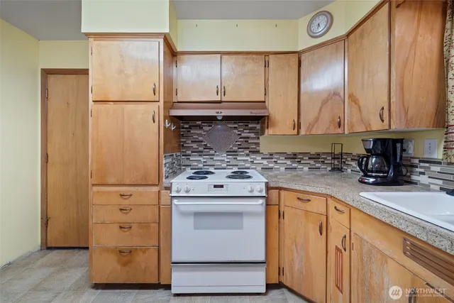 a kitchen with a refrigerator a sink and cabinets