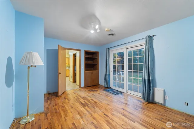 a view of empty room with wooden floor