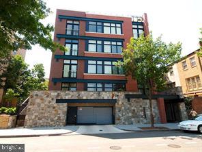 1654 Euclid Street Northwest, Unit 105 Washington, DC 20009 - Photo 1 of 29 a front view of a building with glass windows