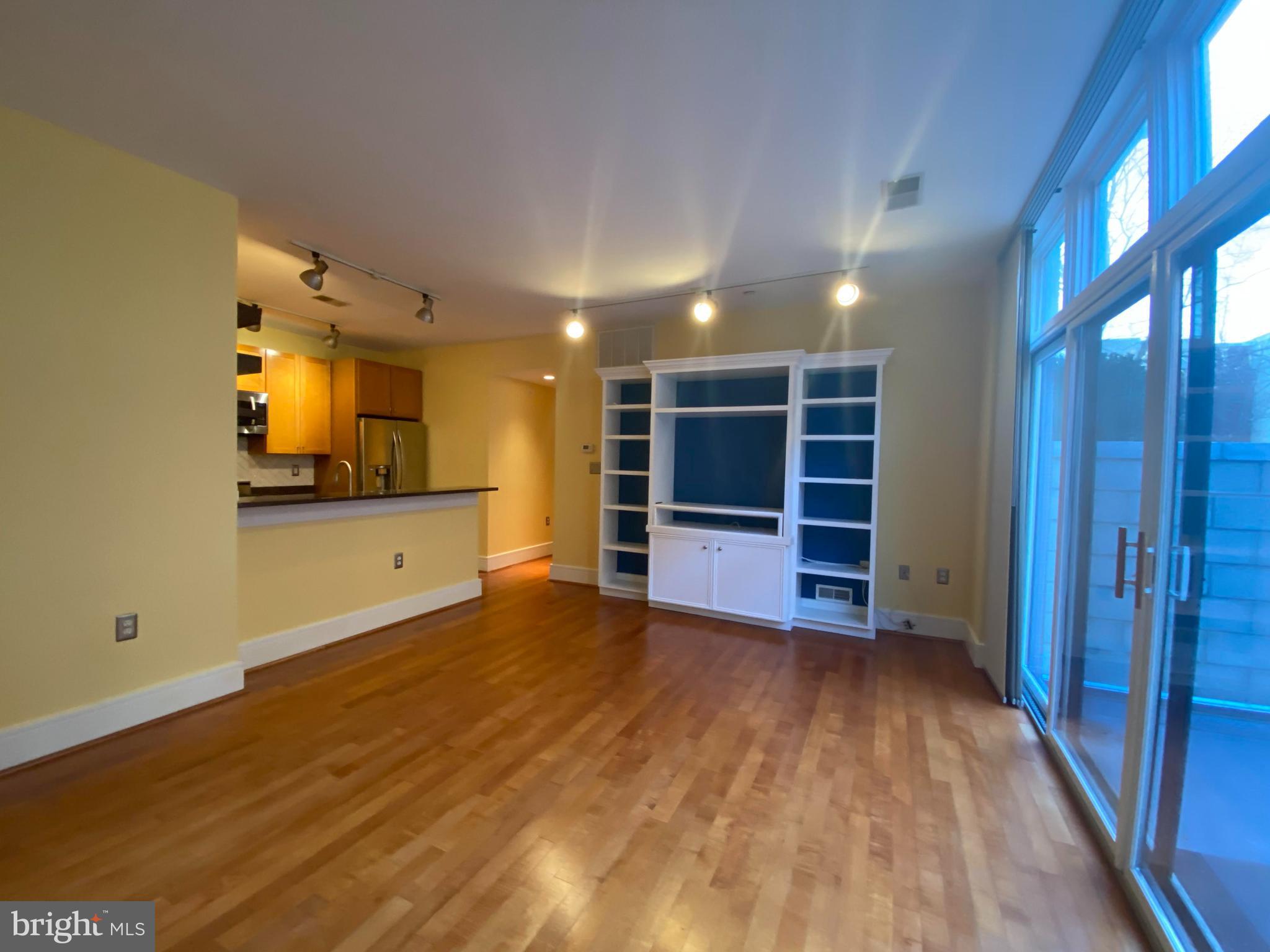 1654 Euclid Street Northwest, Unit 105 Washington, DC 20009 - Photo 12 of 29 a view of a room with a flat screen tv wooden floor and window