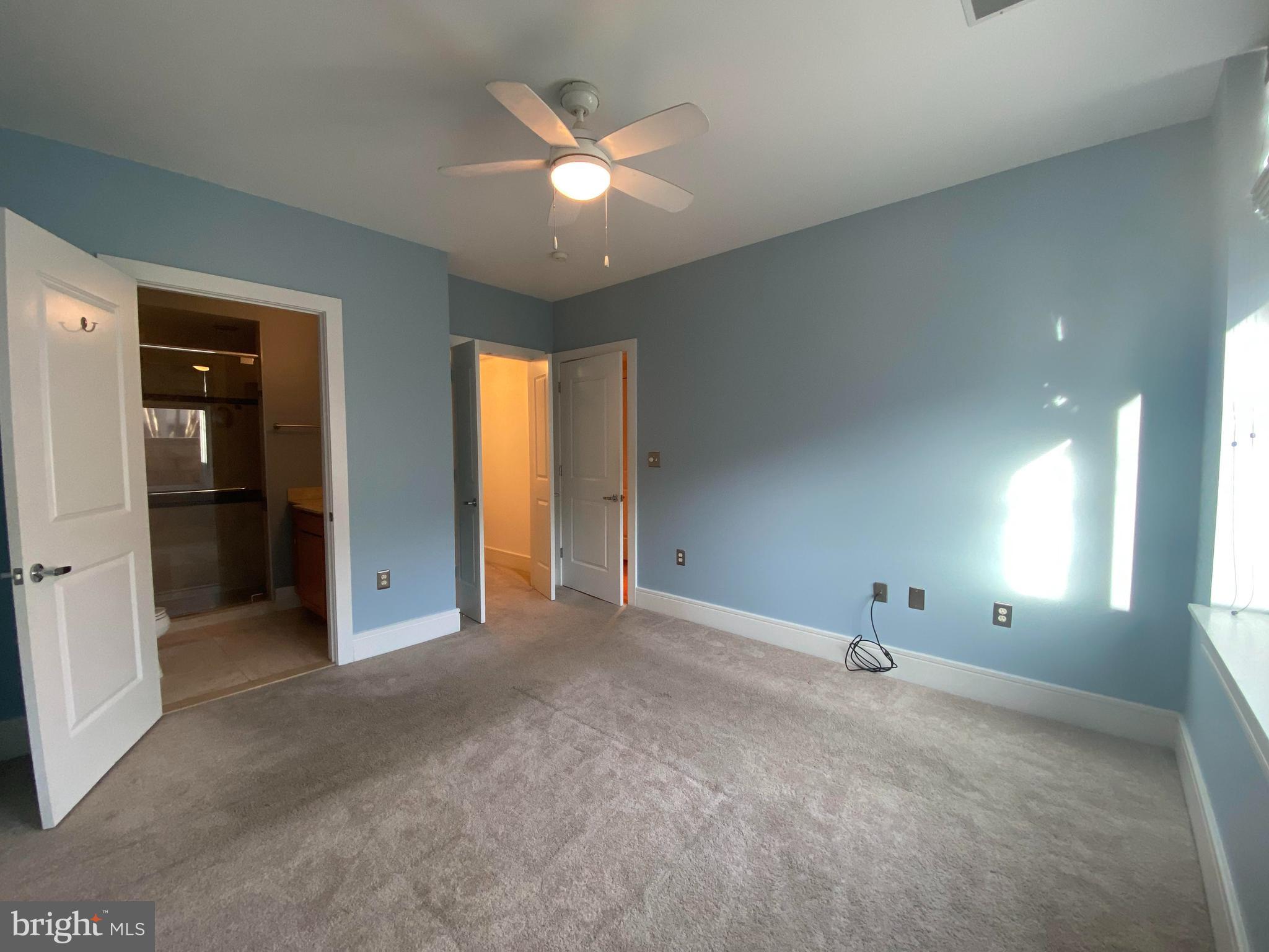 1654 Euclid Street Northwest, Unit 105 Washington, DC 20009 - Photo 17 of 29 an empty room with fan and windows