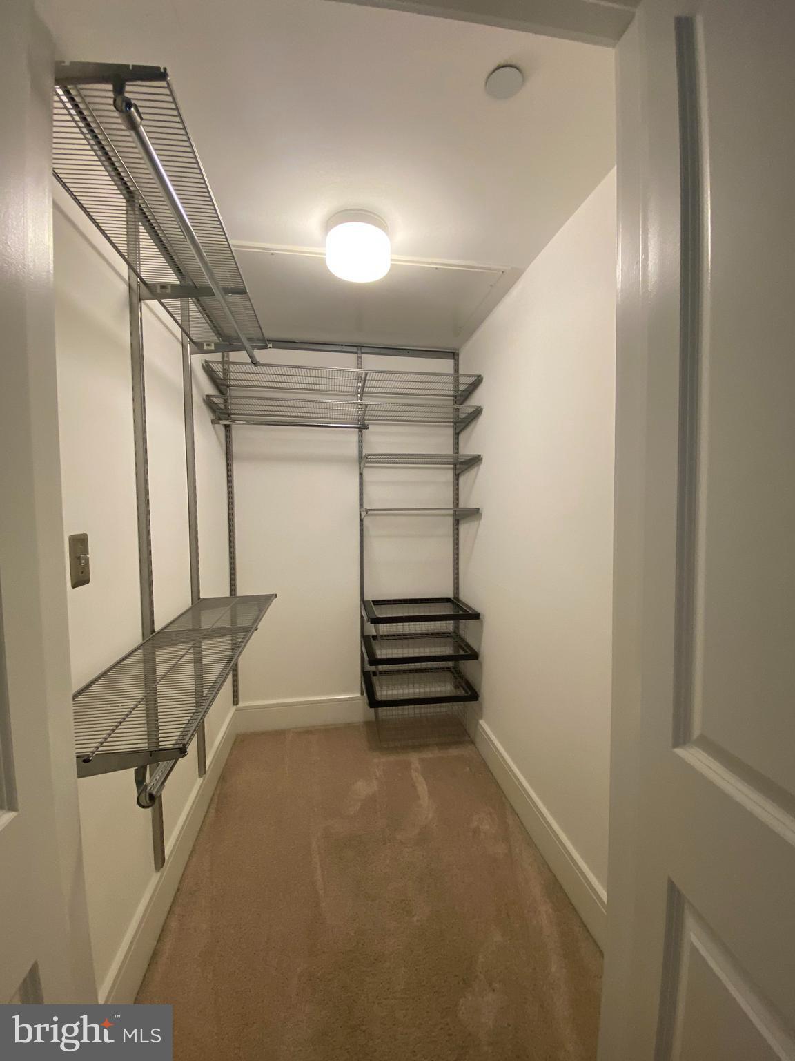 1654 Euclid Street Northwest, Unit 105 Washington, DC 20009 - Photo 18 of 29 a view of walk in closet with stairs