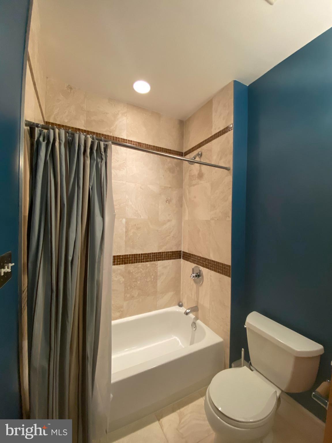 1654 Euclid Street Northwest, Unit 105 Washington, DC 20009 - Photo 24 of 29 a bathroom with a toilet and a shower
