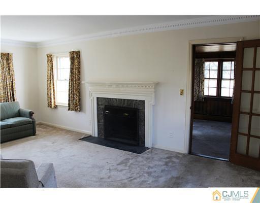 75 Stafford Road Colonia, NJ 07067 - Photo 2 of 10 a living room with furniture and a fireplace