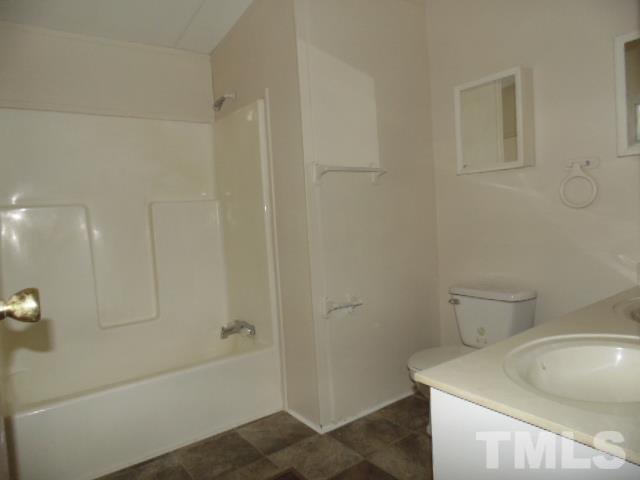 4522 Thomas Road Henderson, NC 27537 - Photo 16 of 19 a bathroom with a sink a toilet and shower