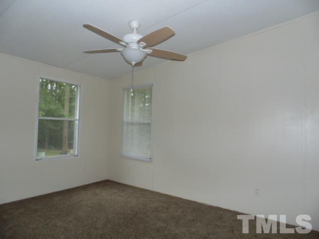4522 Thomas Road Henderson, NC 27537 - Photo 18 of 19 an empty room with windows and fan