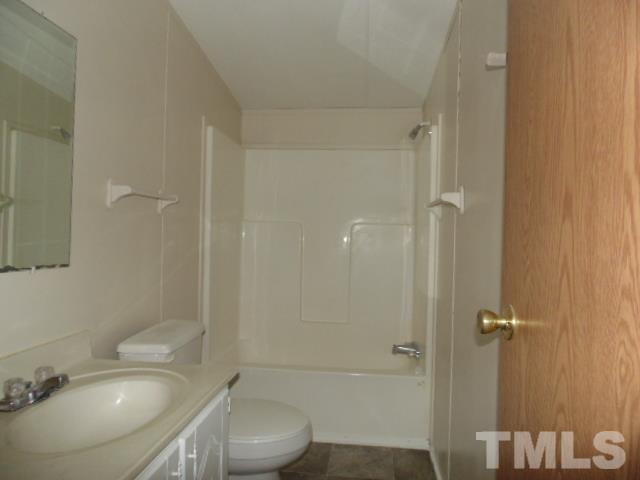 4522 Thomas Road Henderson, NC 27537 - Photo 19 of 19 a bathroom with a sink toilet and shower