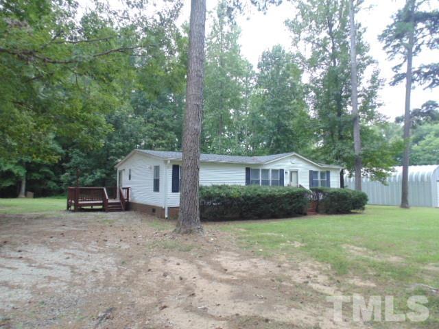 4522 Thomas Road Henderson, NC 27537 - Photo 3 of 19 a view of a house with a yard and large trees