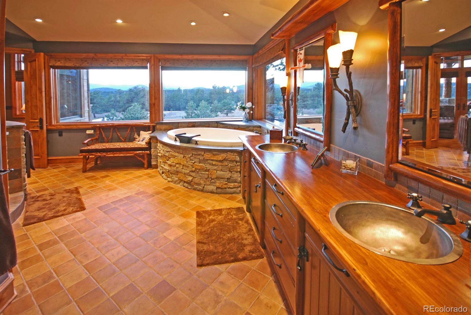 2127 Wieler Road Evergreen, CO 80439 - Photo 16 of 35 a bathroom with a tub sink and mirror