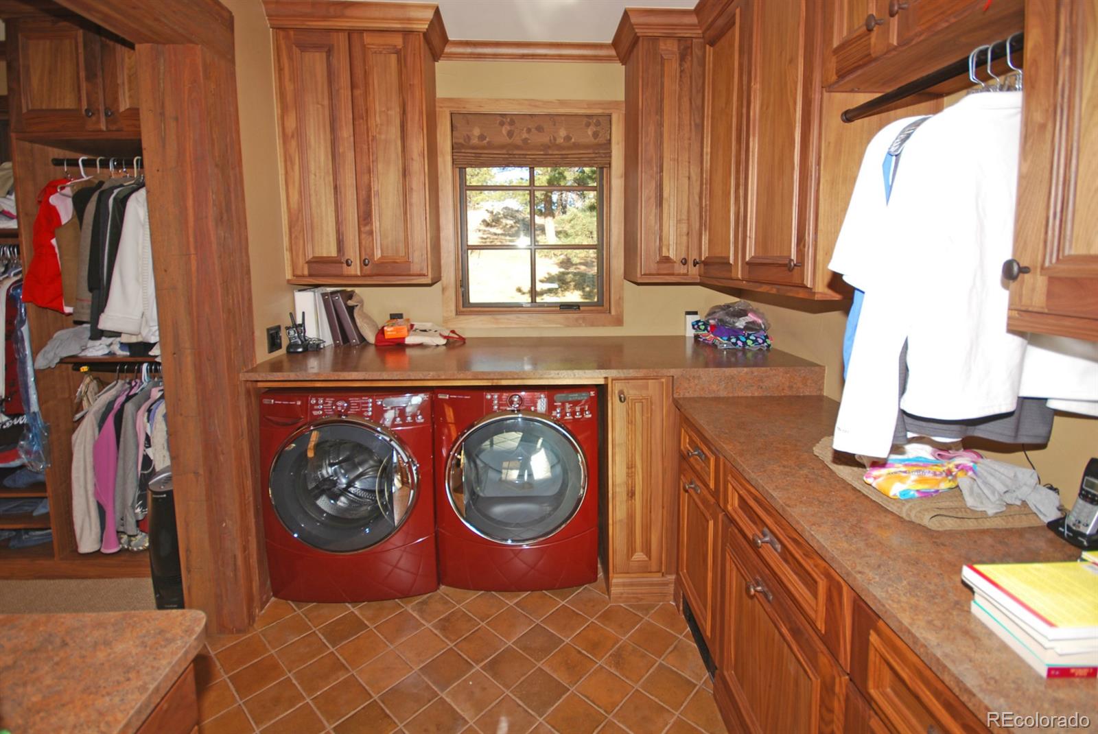2127 Wieler Road Evergreen, CO 80439 - Photo 17 of 35 a view of a storage and utility room with washer and dryer