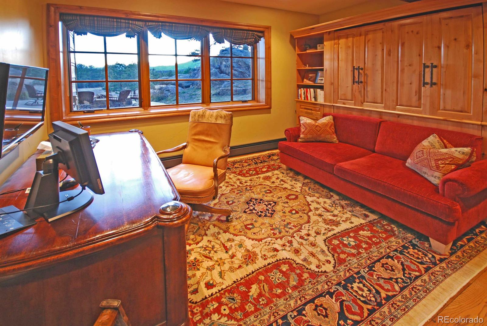 2127 Wieler Road Evergreen, CO 80439 - Photo 29 of 35 a living room with blue lights with furniture