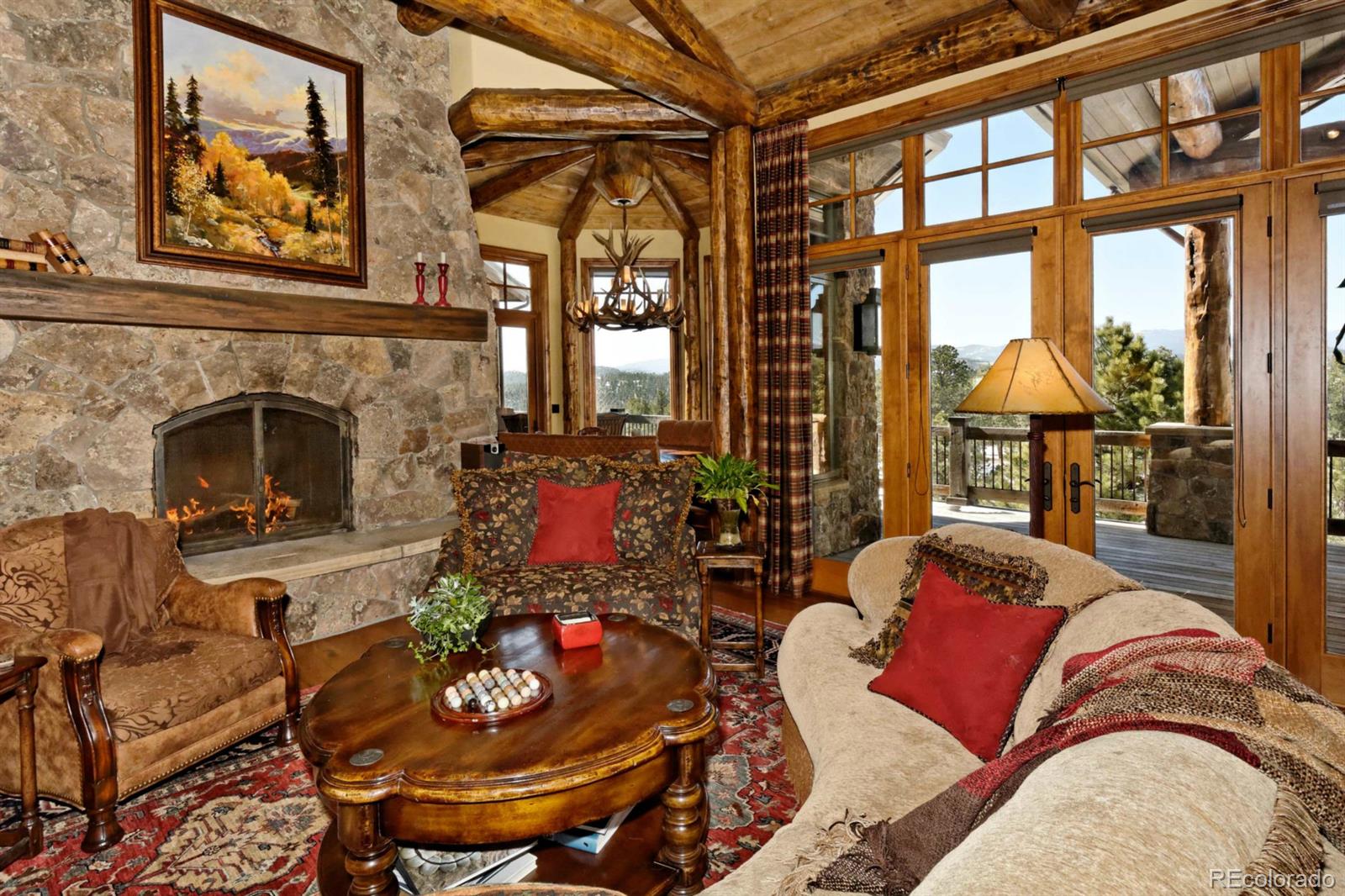 2127 Wieler Road Evergreen, CO 80439 - Photo 7 of 35 a living room with furniture and a fireplace