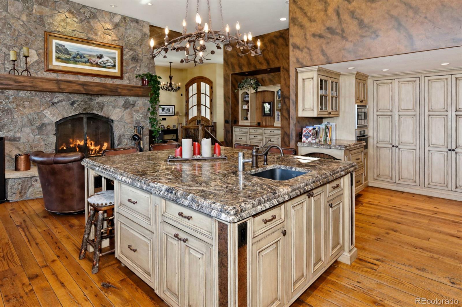 2127 Wieler Road Evergreen, CO 80439 - Photo 9 of 35 a kitchen with stainless steel appliances granite countertop a sink cabinets and wooden floor