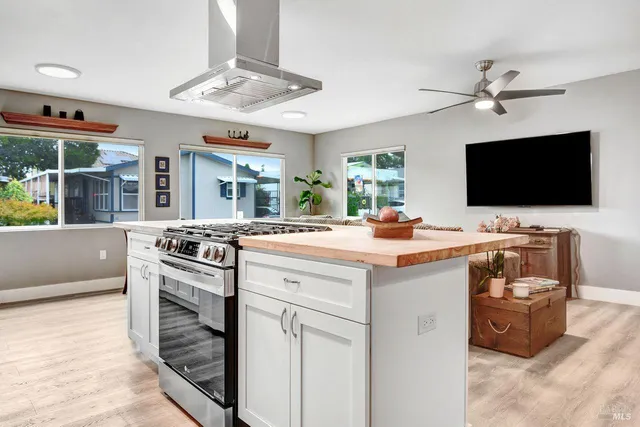 a kitchen with stainless steel appliances a stove a sink and a microwave