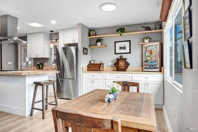 a kitchen with stainless steel appliances granite countertop a refrigerator and microwave