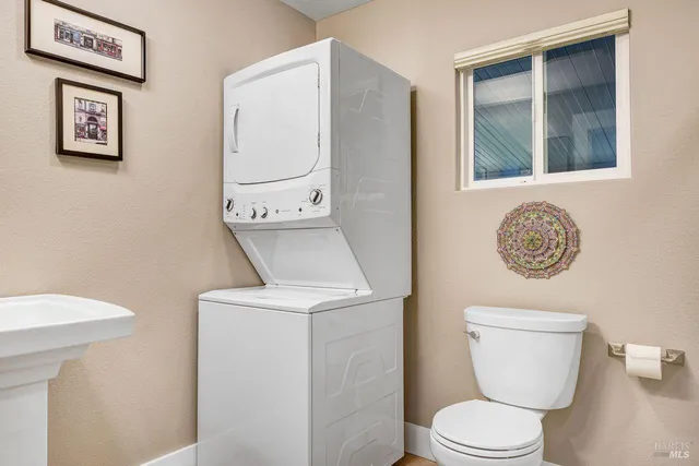 a white toilet sitting next to a bathroom sink
