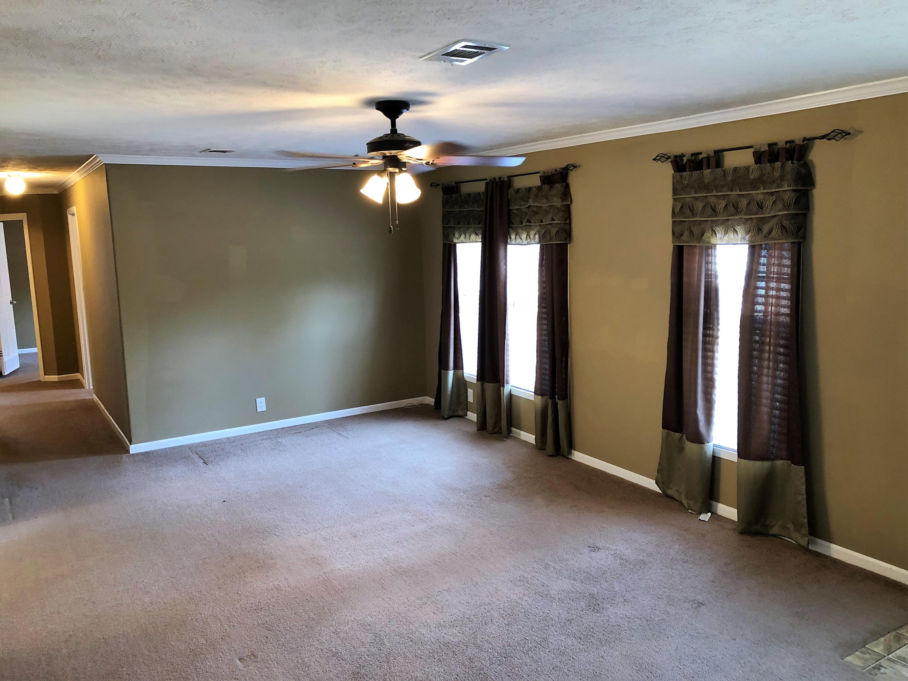 168 Lucas Road DeFuniak Springs, FL 32433 - Photo 3 of 25 an empty room with windows and fan