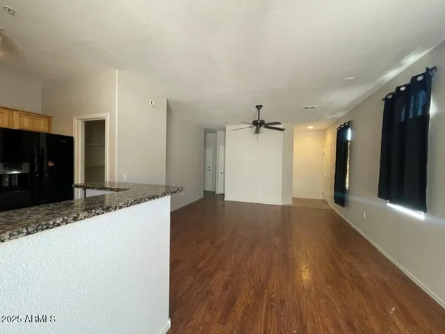 a view of a kitchen with a sink and a refrigerator