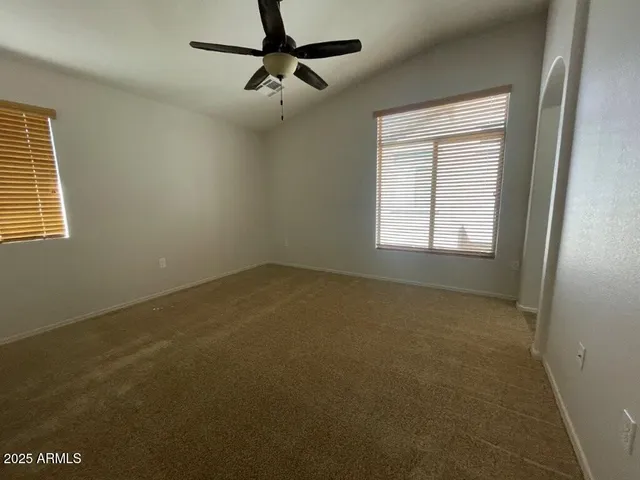 a view of a livingroom with a ceiling fan and window