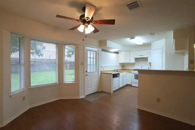 a kitchen with kitchen island stainless steel appliances a window and a refrigerator