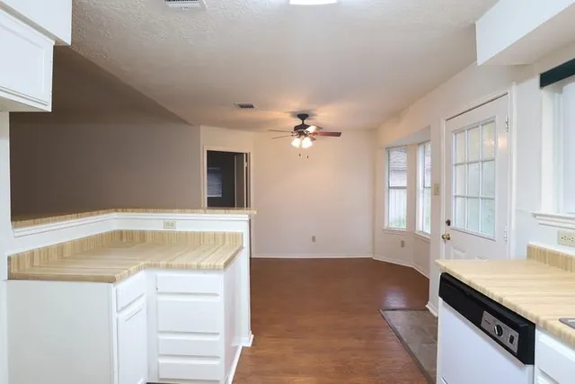 a kitchen with granite countertop a stove and a sink
