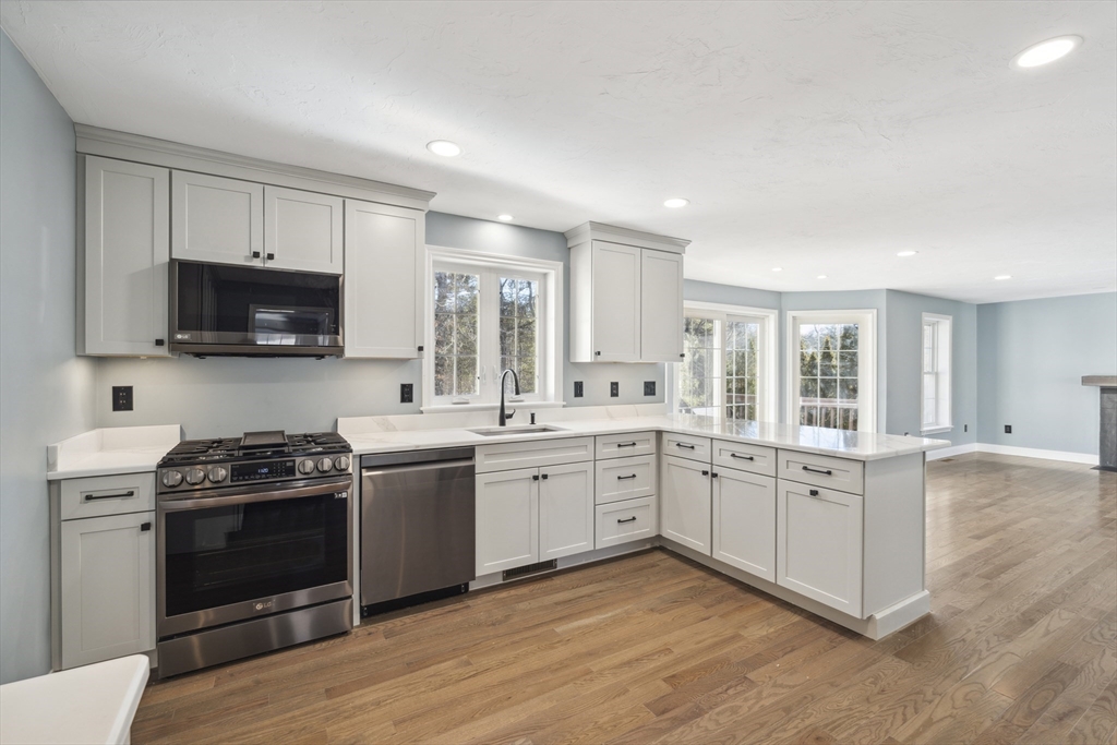 6 Coppersmith Way Townsend, MA 01469 - Photo 2 of 33 a kitchen with a stove a sink and a microwave