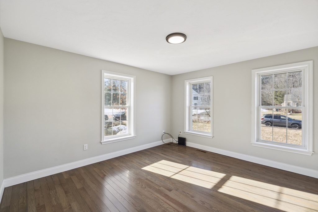 6 Coppersmith Way Townsend, MA 01469 - Photo 10 of 33 a view of an empty room with window and wooden floor