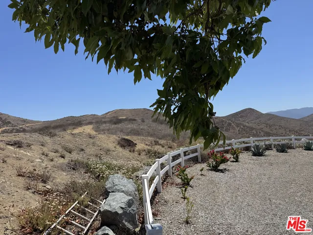 a view of a backyard of a house with a mountain
