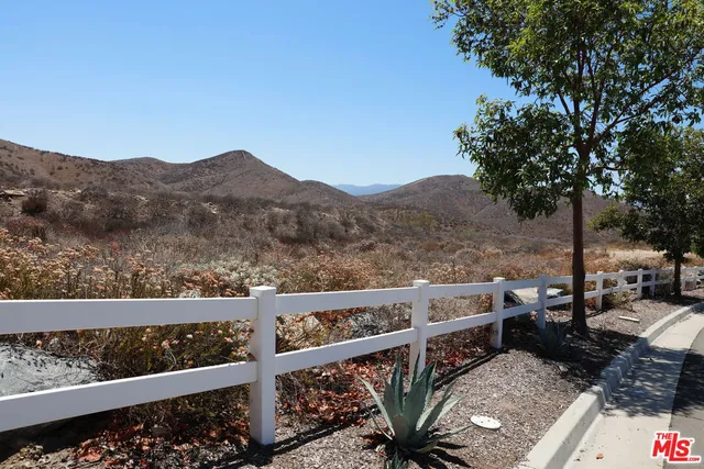 a view of a balcony with wooden fence