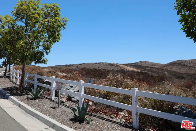 a view of a balcony with wooden fence and floor