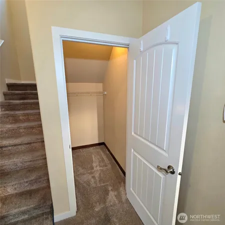 a view of a hallway with wooden shelves