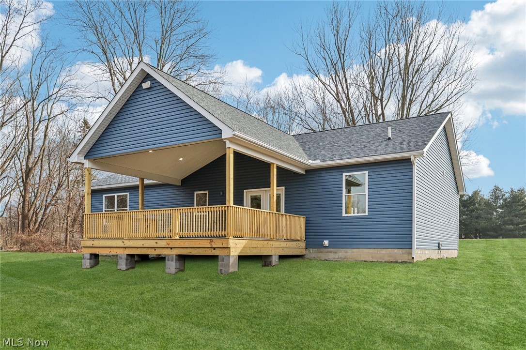 6535 North Ridge Road West Geneva, OH 44041 - Photo 42 of 48 Back of house with a lawn, roof with shingles, and a deck