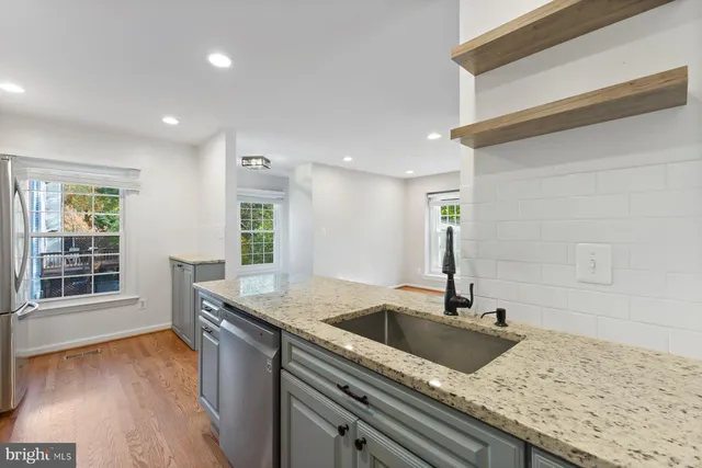 an empty room with floor to ceiling window and fireplace