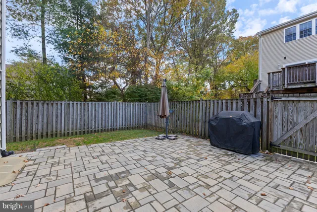a view of a house with backyard and a tree