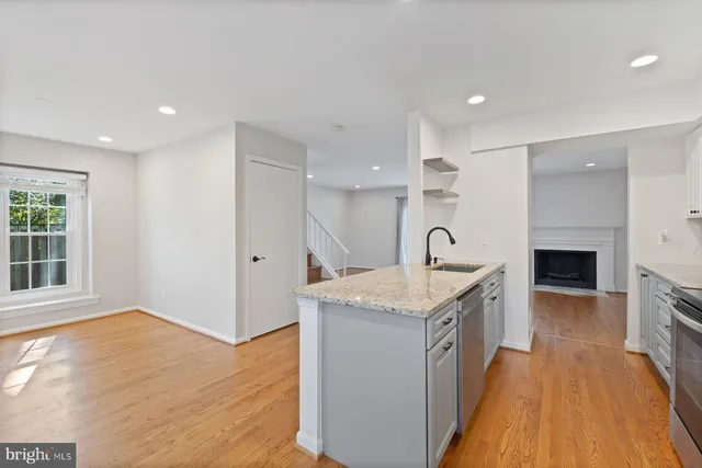a kitchen with stainless steel appliances granite countertop a sink and a stove