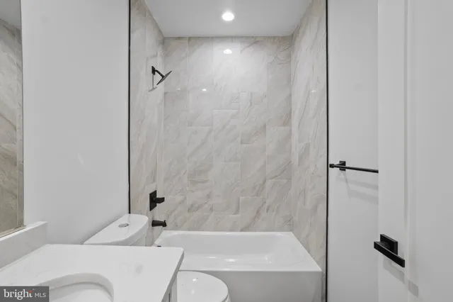a bathroom with a bathtub and shower